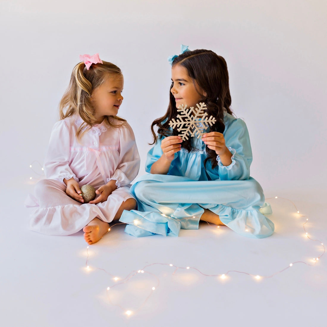 Two little girls wearing pink & blue nightgowns