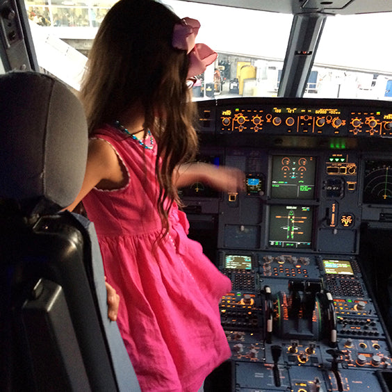 Classic Girl Clothing pink linen dress on girl in a plane