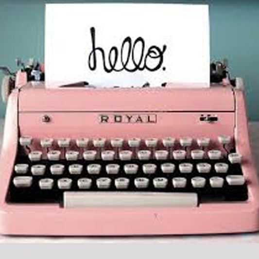 Pink vintage type writer with "Hello" on paper