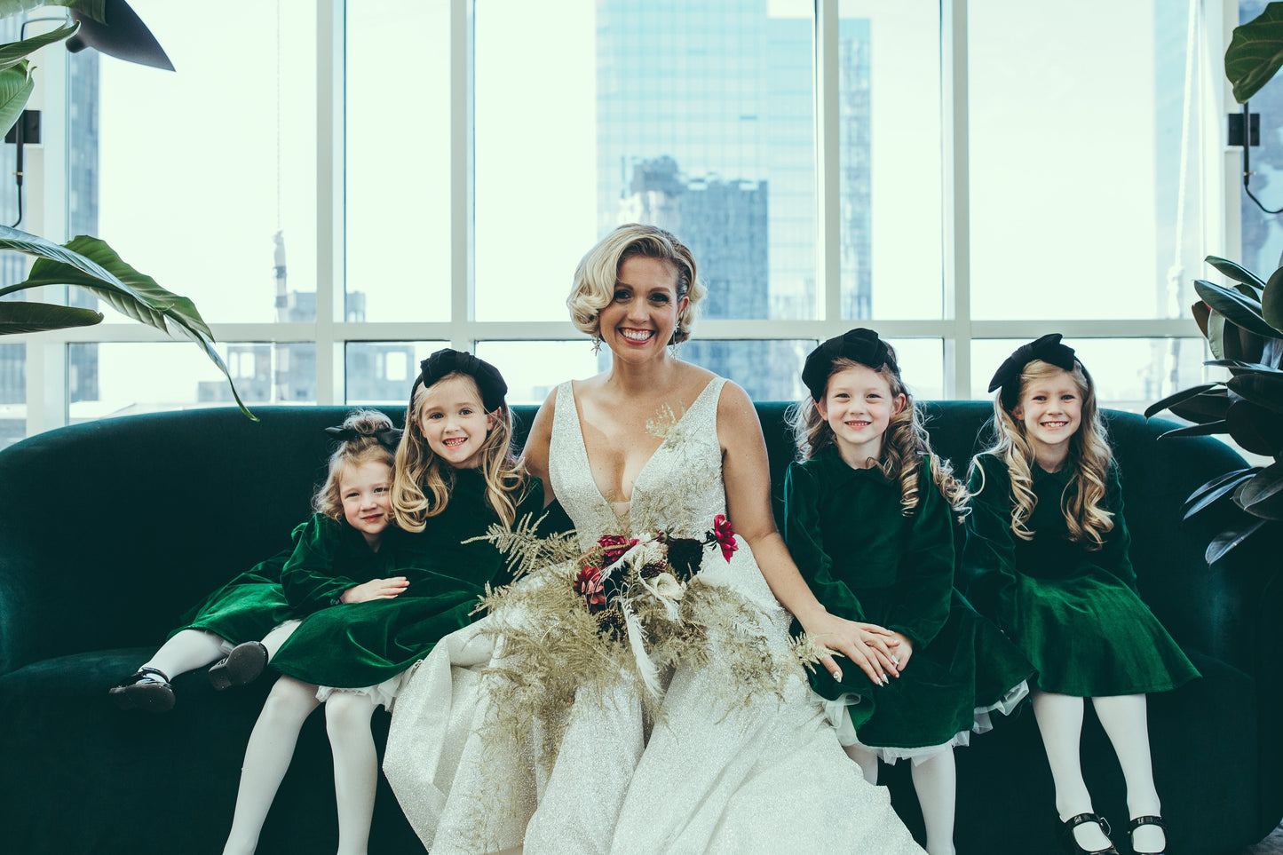 Bride with four little girls in a green velvet dresses.